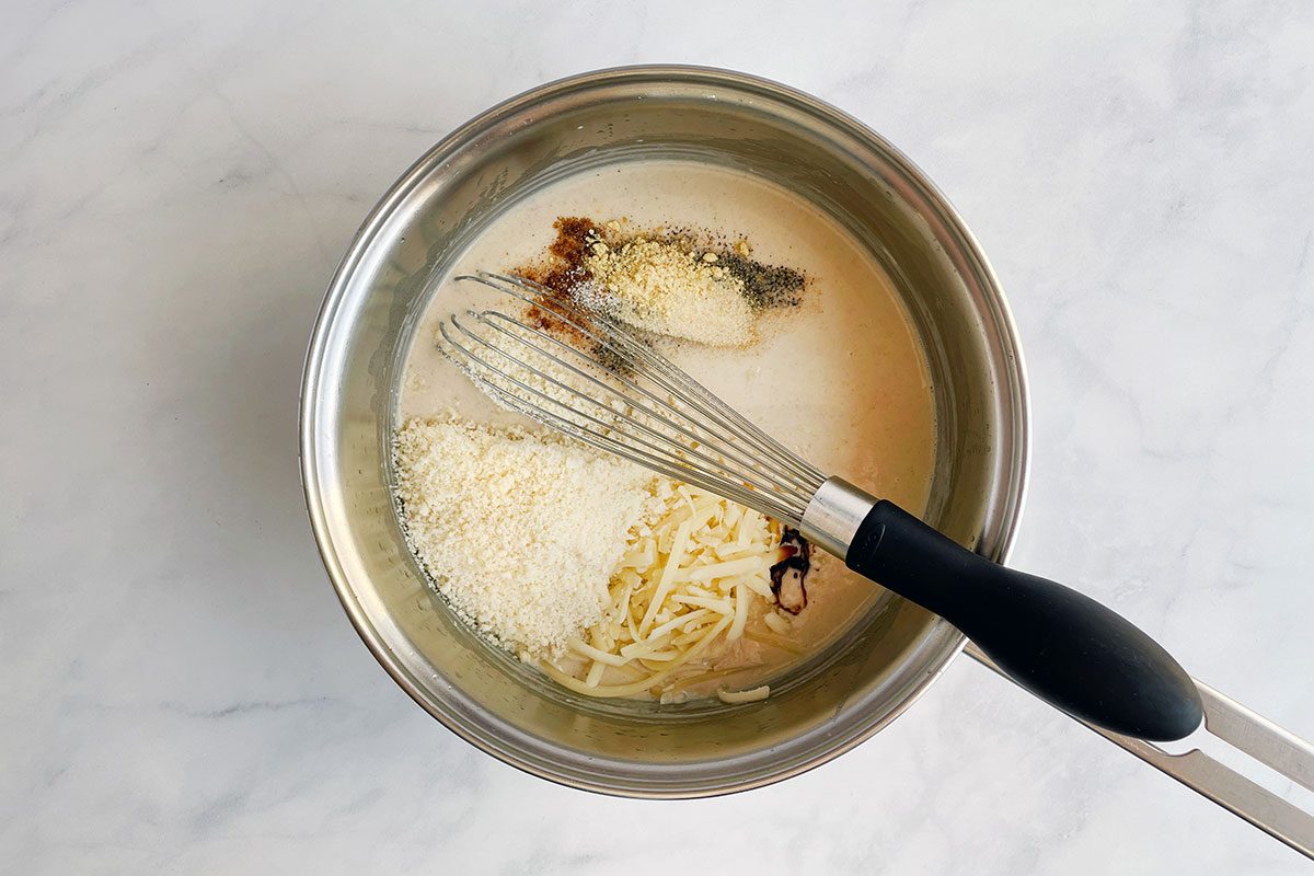 How to make Taste of Home's Cauliflower Gratin, step 2: adding cheese and milk to roux to make a thick sauce