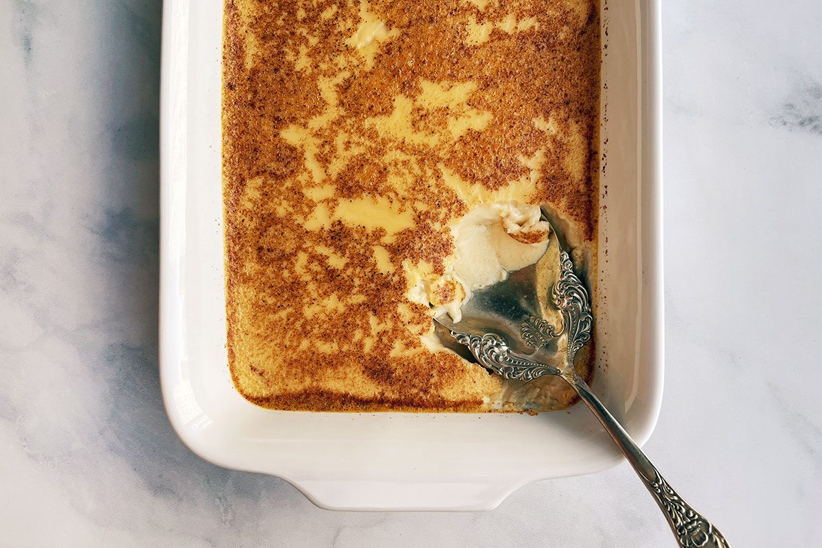 Overhead shot of Taste of Home's Baked Egg Custard in a serving dish on a white marble background