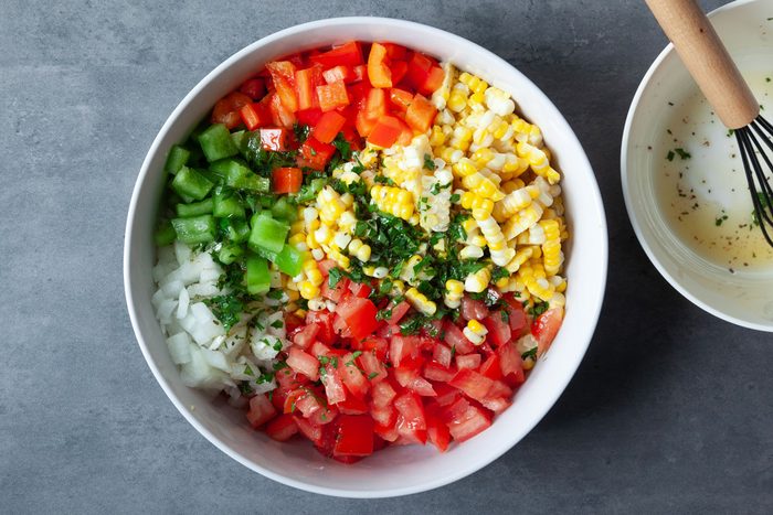 Step 4 of Taste of Home Fresh Corn Salad is to combine the vegetables in a large bowl and toss with dressing