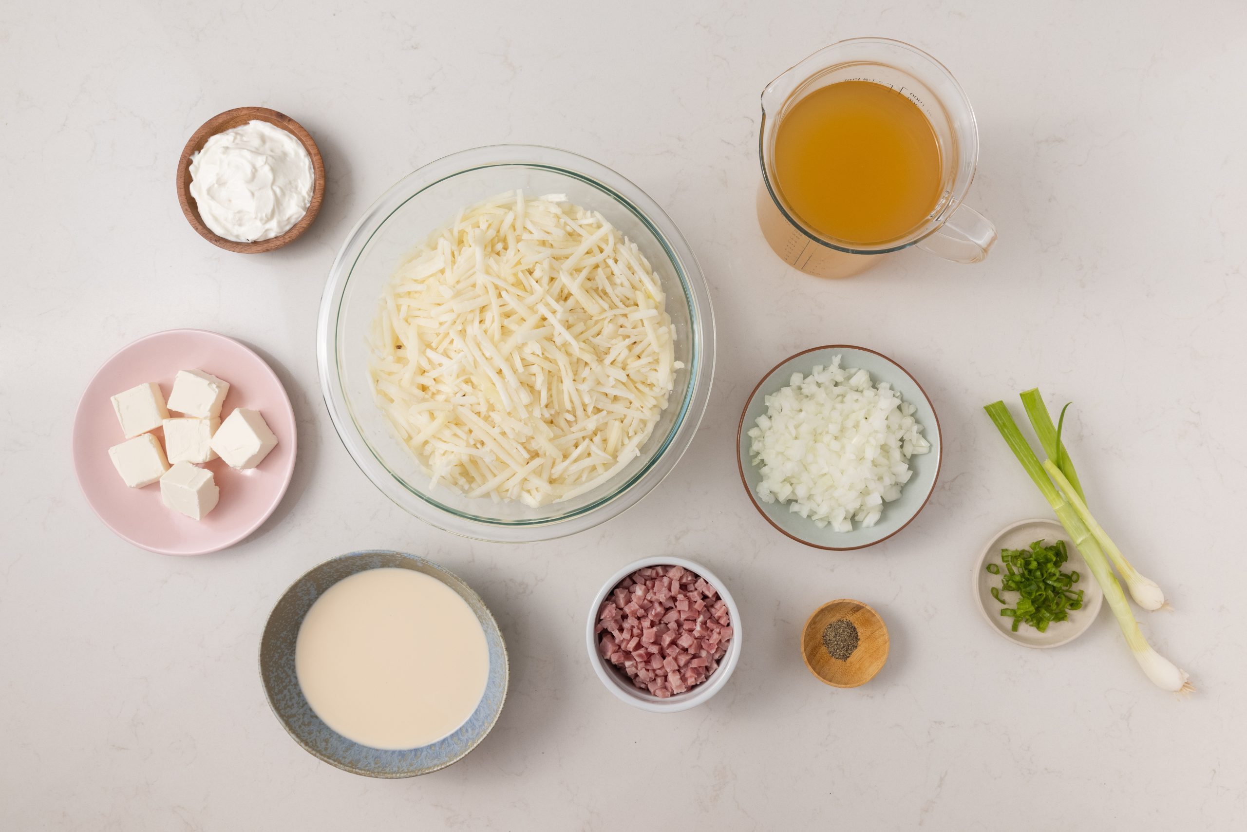 Ingredients for slow cooker potato and ham soup on kitchen counter.