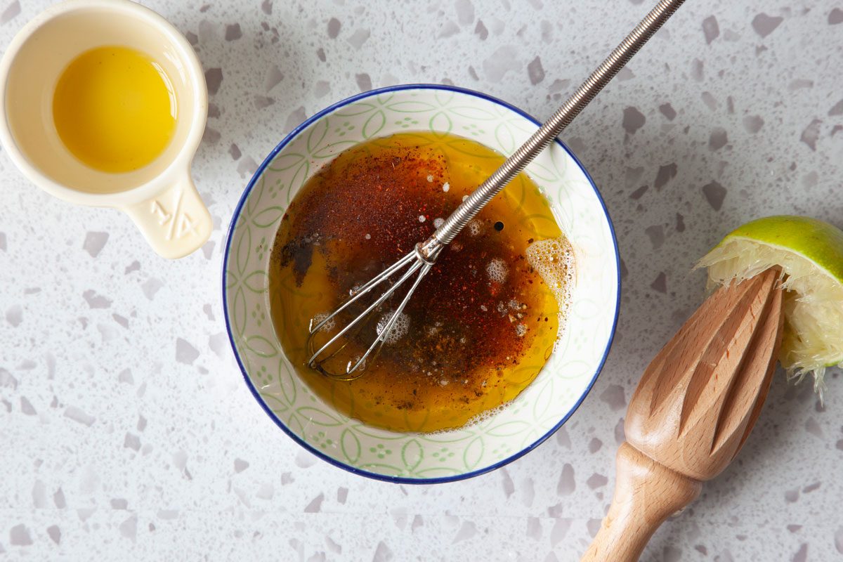 olive oil, balsamic vinegar, lime juice, salt, pepper and chili powder in a small bowl with a small whisk