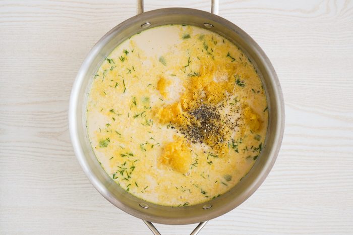 Simmering together acorn squash soup