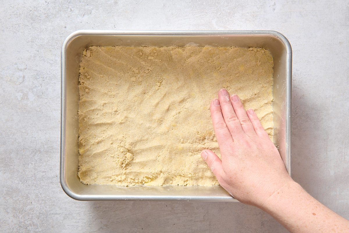 Pressing the crust into a baking pan