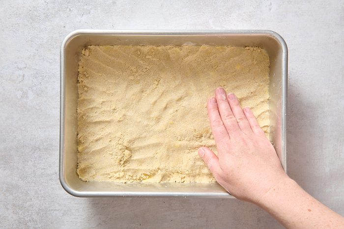 Pressing the crust into a baking pan