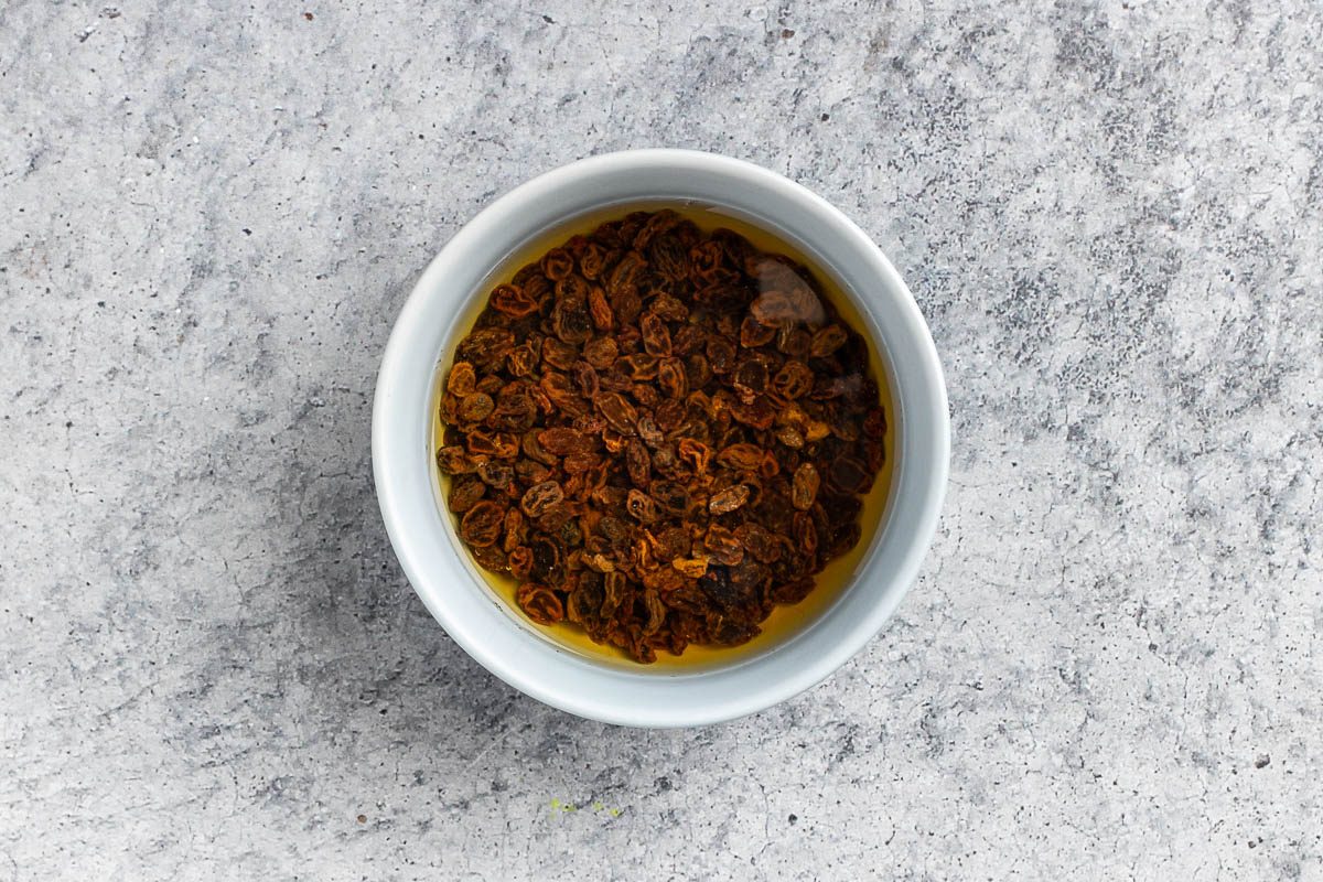 Taste of Home Applesauce Cake photo of the raisins soaking in water.