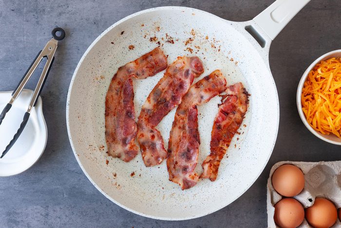 Step 1 of Taste of Home Bacon and Egg Muffins is to cook the bacon is a skillet And Egg Muffins Tohd24 36194 Sarahtramonte 1