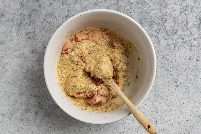 Taste of Home Chicken Loaf recipe photo of combining the chicken mixture with the ground chicken.