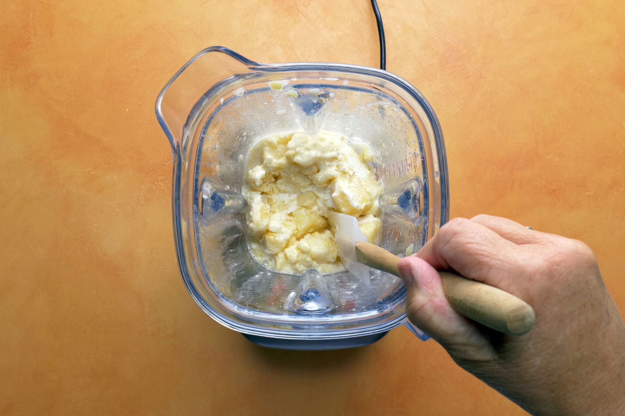Stopping and scraping sides as needed with spatula