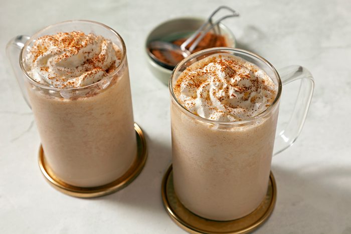 Wide shot of Copycat Starbucks Pumpkin Spice Frappuccino in two mugs on coasters
