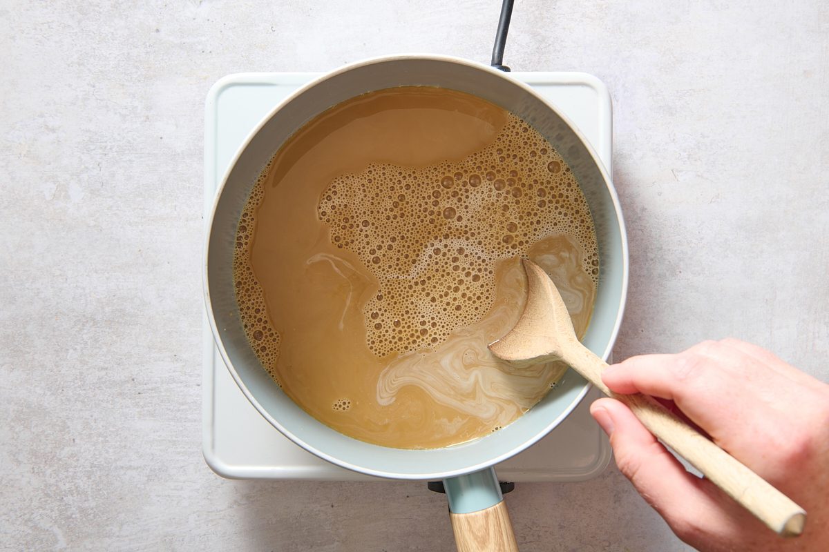 Stirring coffee into the eggnog in a saucepan