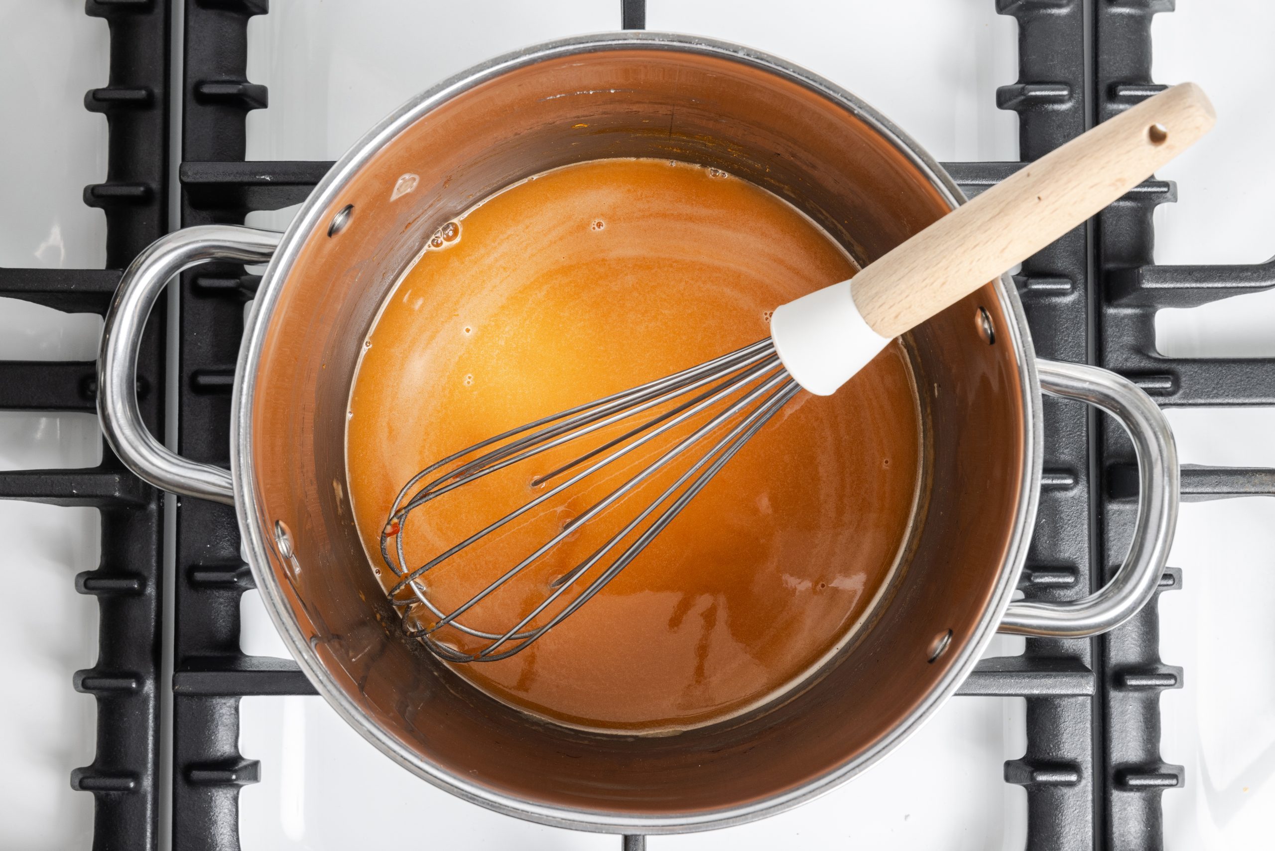 Sauce for stroganoff being prepared in saucepan.