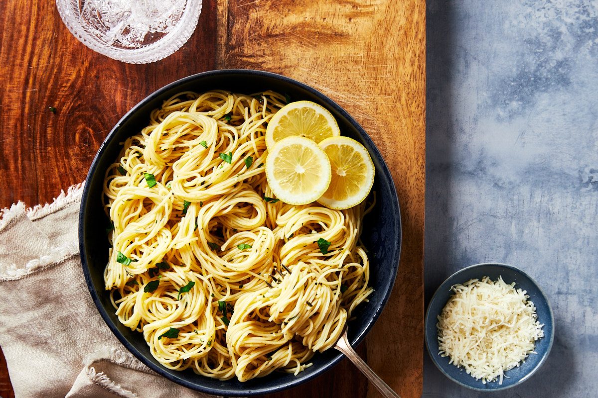 Lemon Pasta Hero- Bowl of lemon pasta garnished with extra parsley and lemon slices
