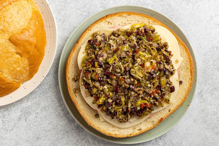 Taste Of Home Muffuletta Recipe Photo Of Assembling The Sandwich.