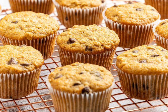 Taste of Home Oatmeal Chocolate Chip Muffins recipe photo of the finished recipe served on plates and a cooling rack.