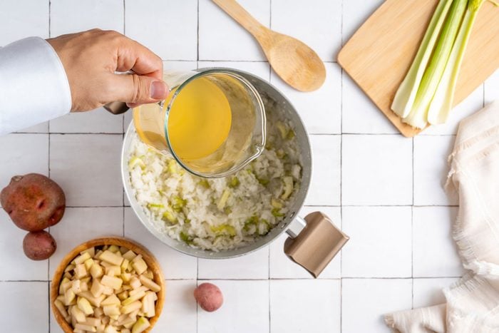 cooking potatoes, onions and broth