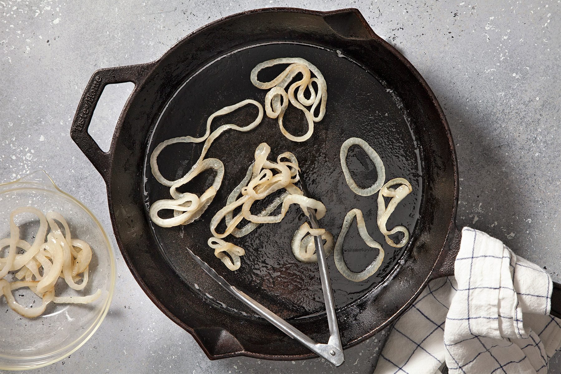 overhead shot; grey textured background; In a large nonstick skillet, saute onion in butter until tender