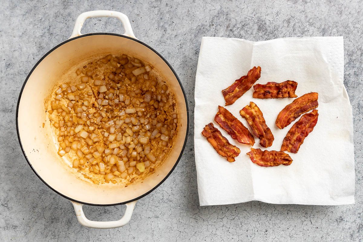 Taste of Home Pumpkin Bisque recipe photo of garlic and onion cooked in dutch oven with side of bacon.