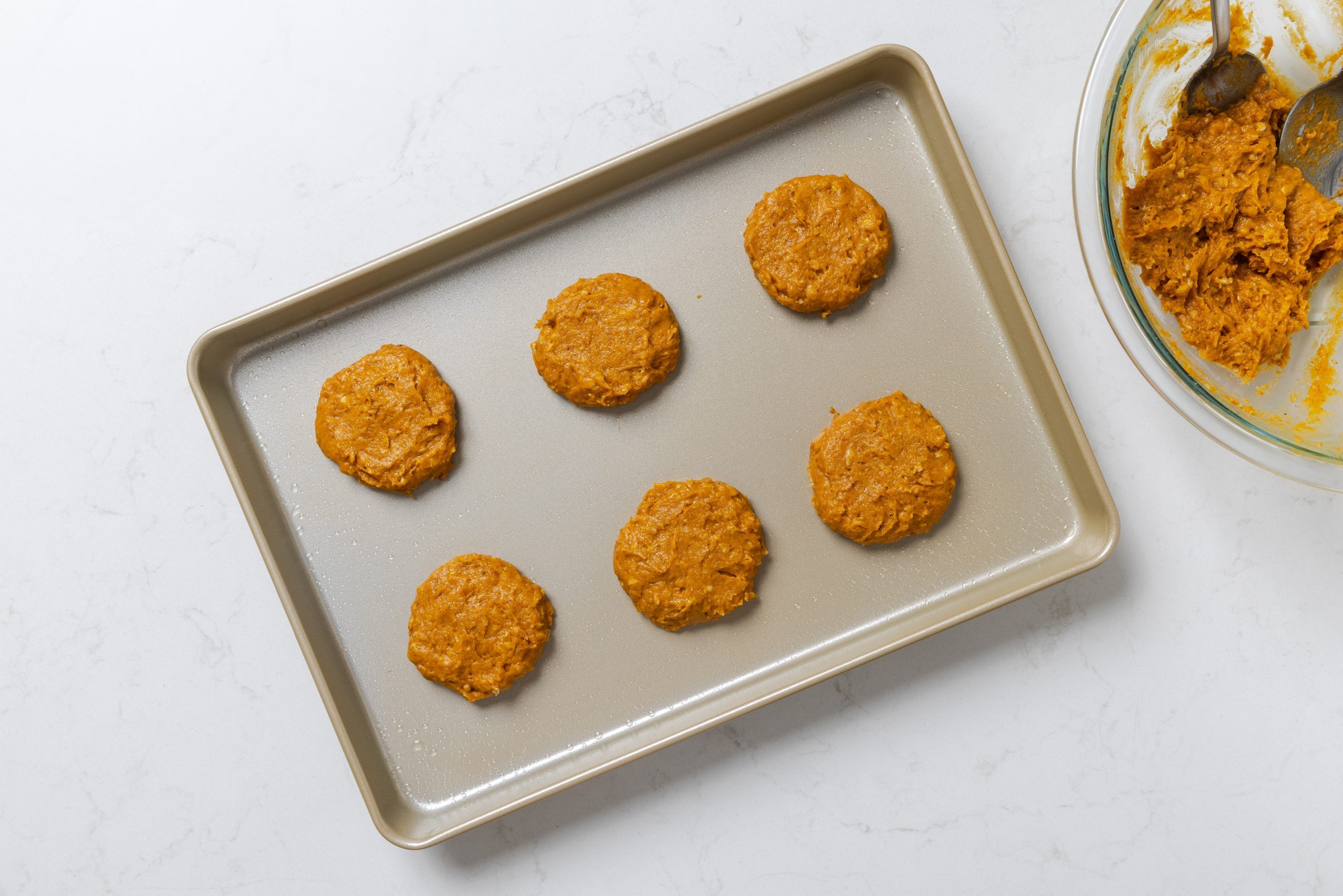 Cookie dough placed in baking sheet.