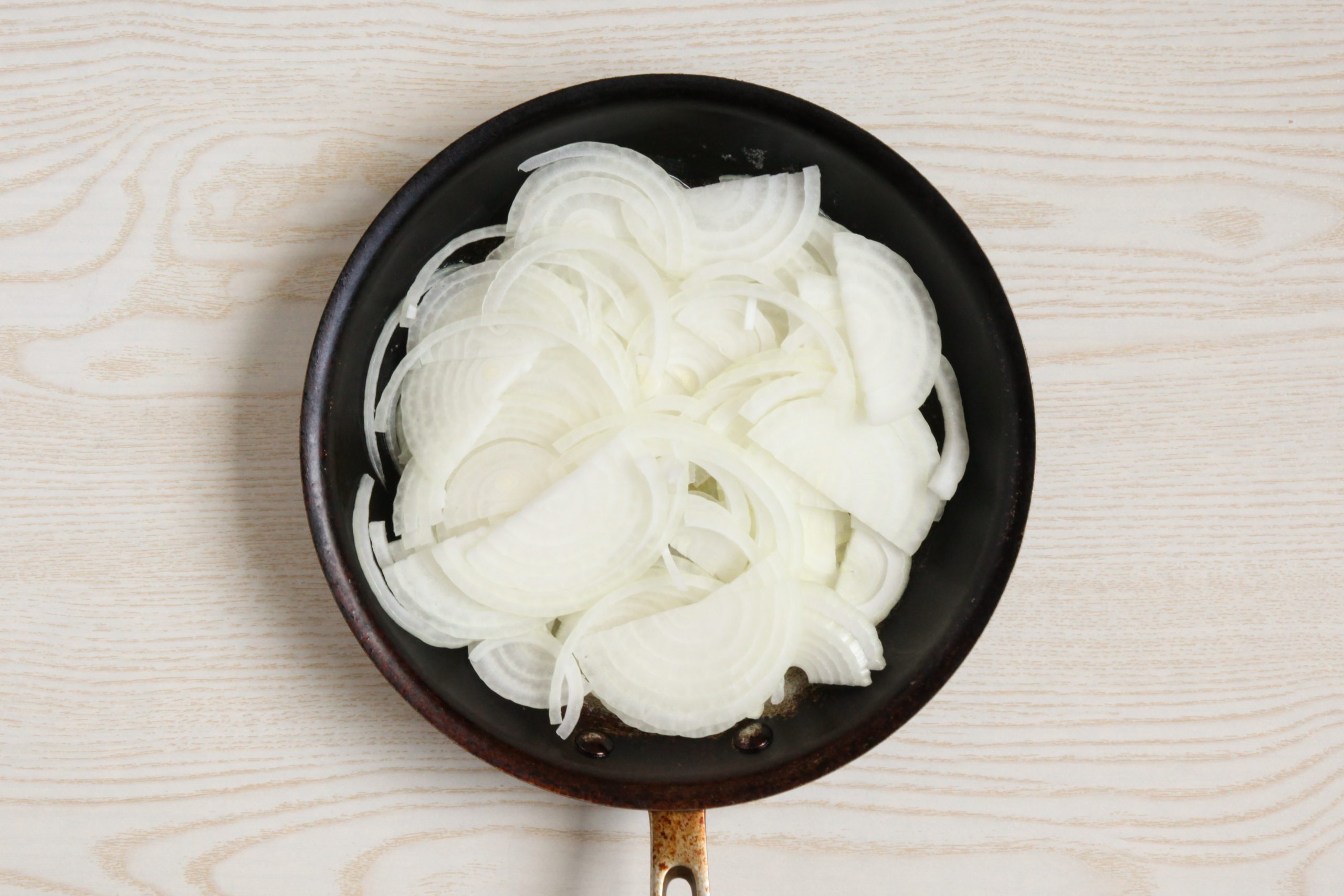 Sliced onions in a skillet