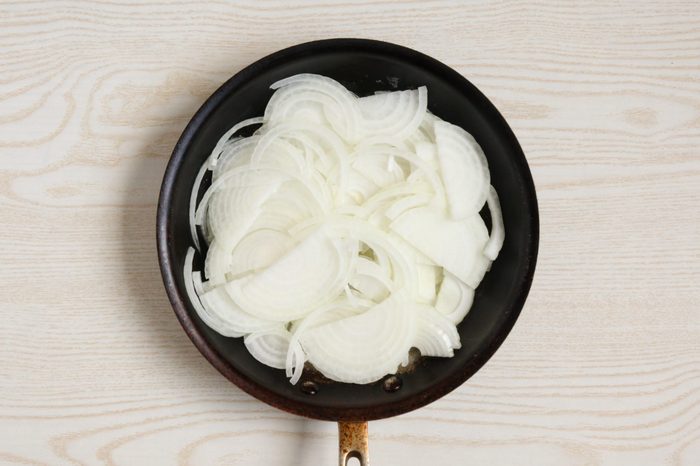 Sliced onions in a skillet