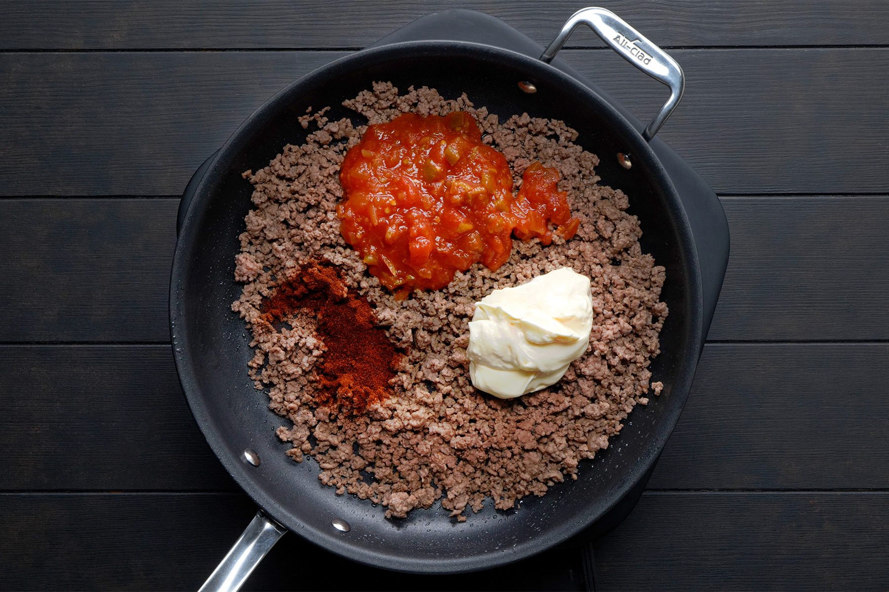 overhead shot; black background; Added the salsa, mayonnaise and chili powder in beef;