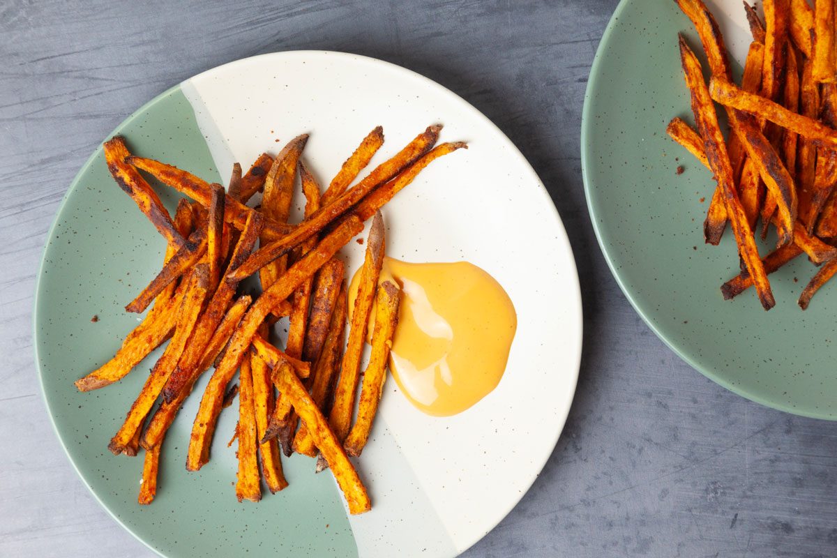 Two plates of Taste of Home Baked Sweet Potato Fries with spicy mayo