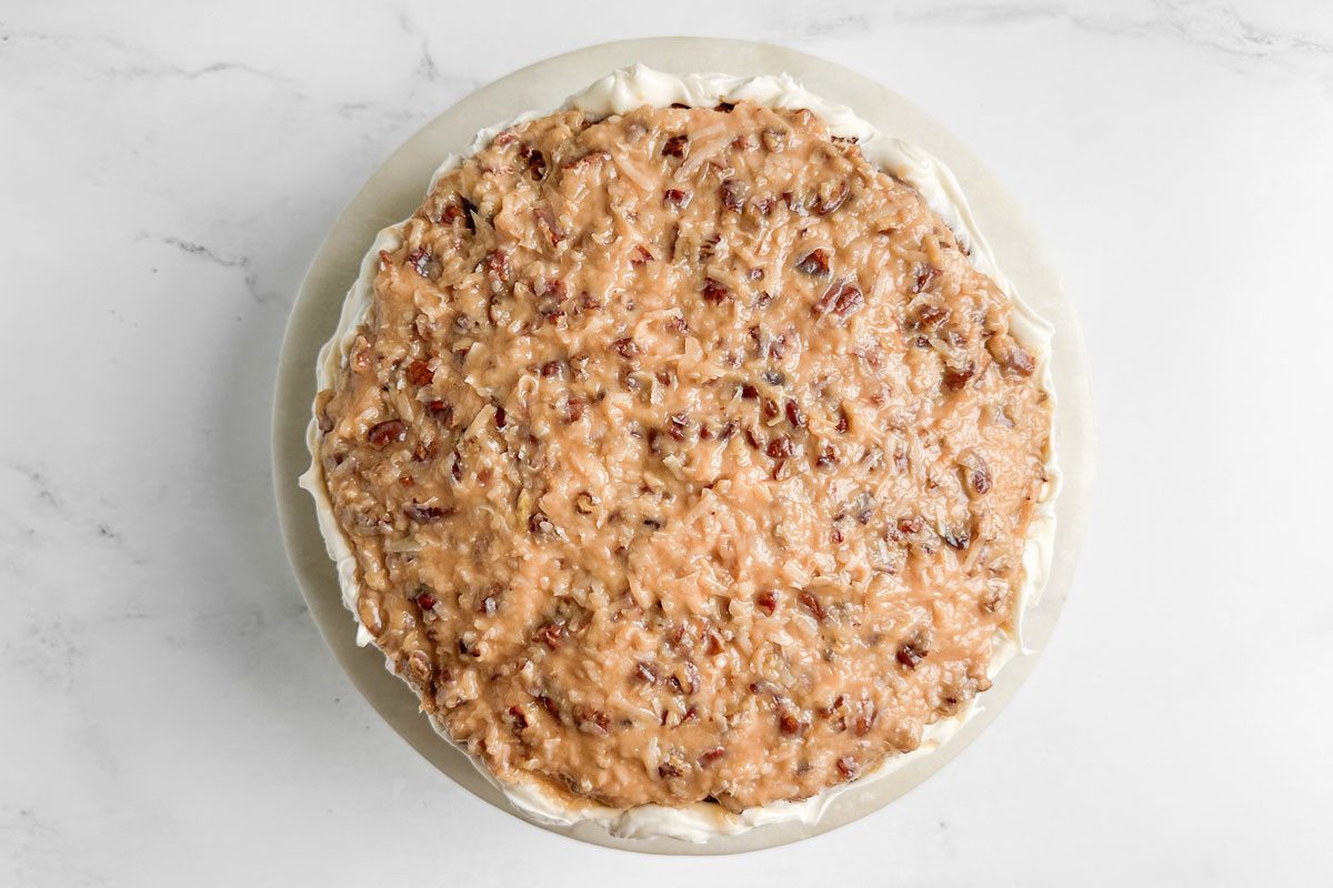 Taste of Home Butterscotch Cake on a marble and wood cake stand