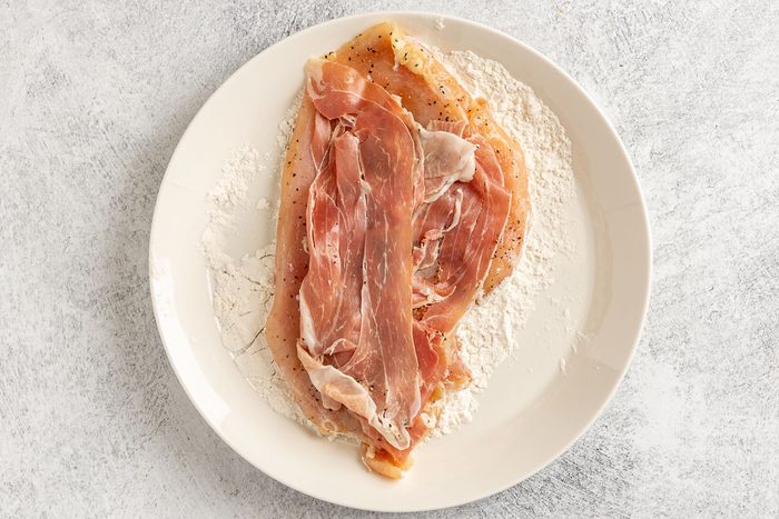 Taste of Home Chicken Saltimbocca photo of the pounded chicken breast topped with fresh sage, proscuitto and then dredged in flour chicken side only.