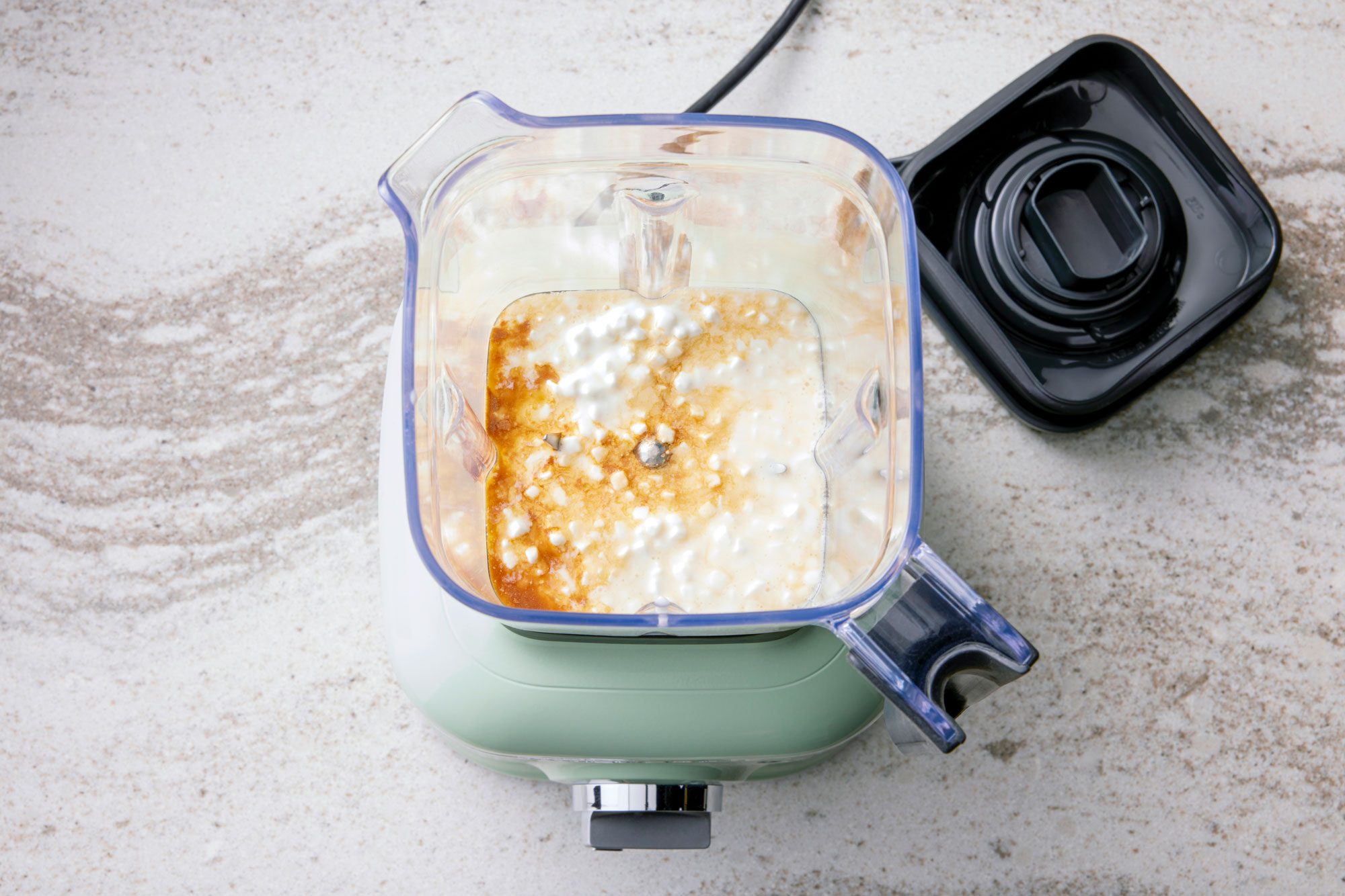 Place cottage cheese, maple syrup and vanilla extract in a blender; puree until smooth.
