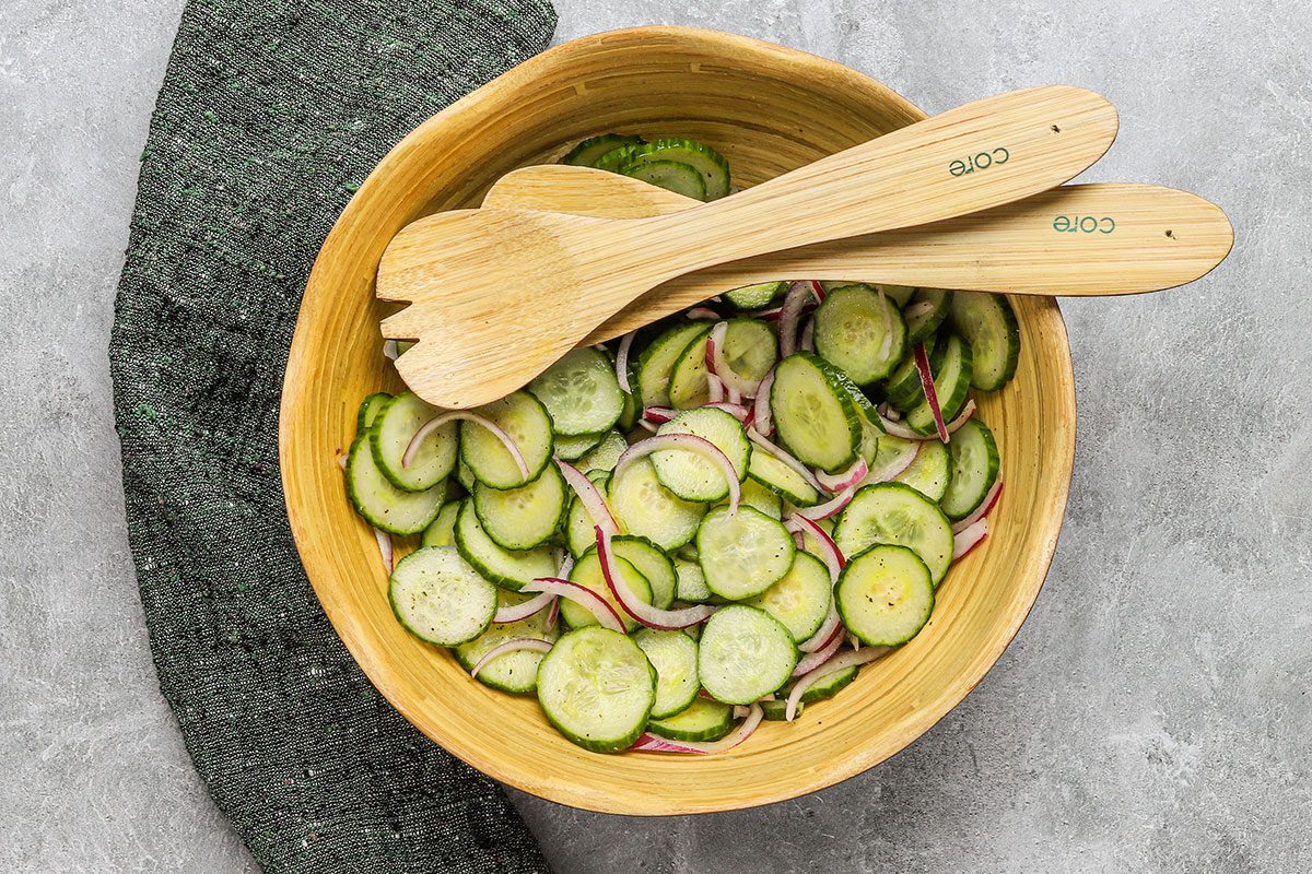 A salad bowl with cucumber and red onion salad.