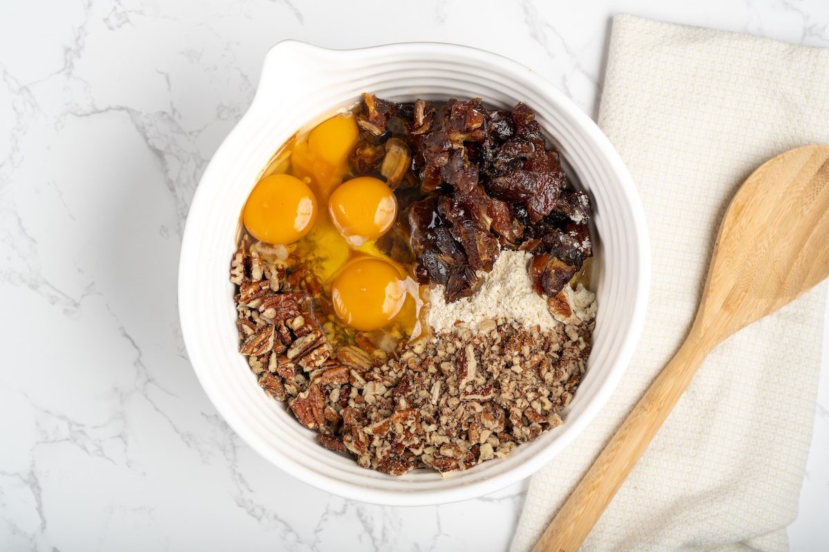 Overhead landscape shot of ingredients for Taste of Homes Date Nut Bars in a mixing bowl.