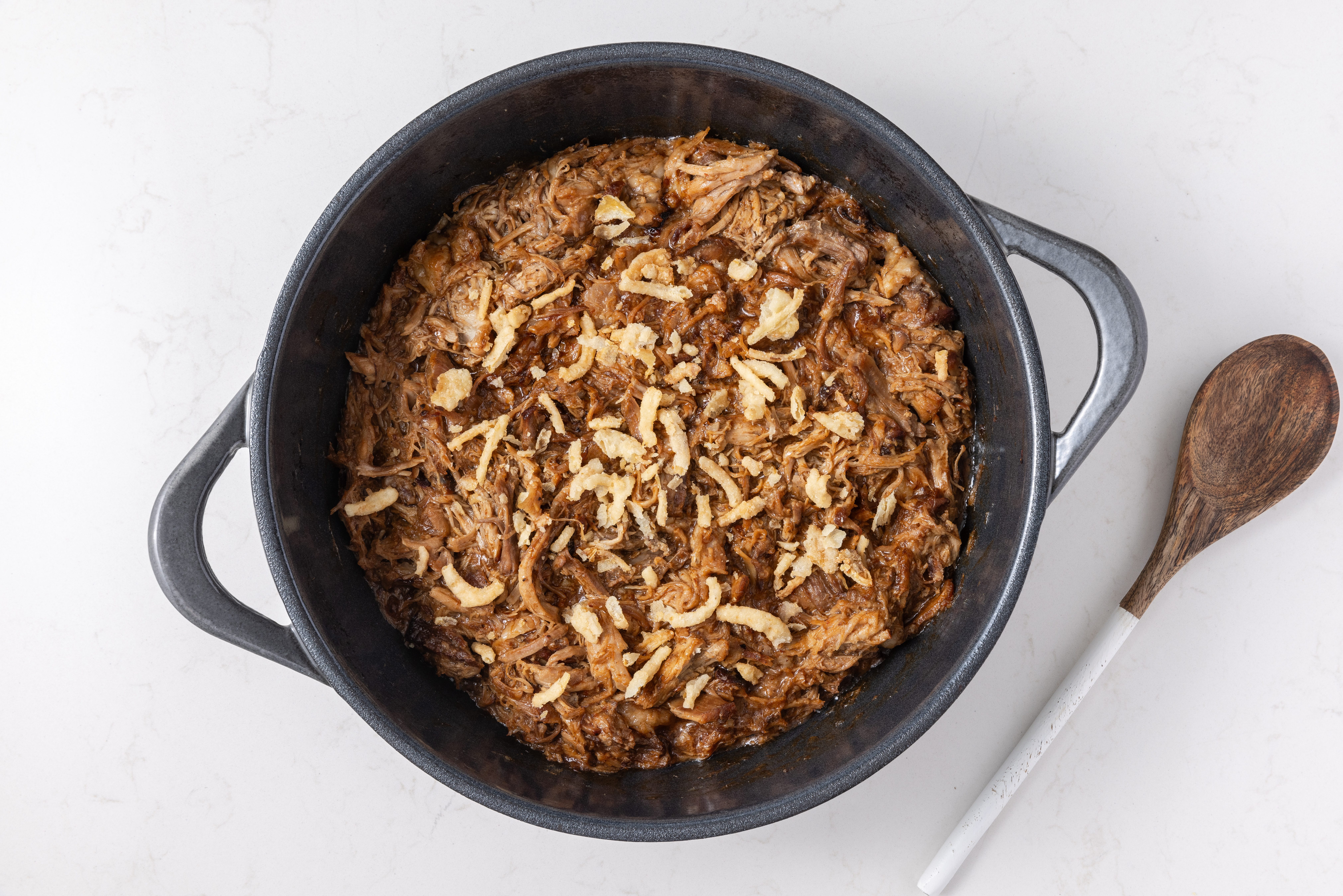 Pulled pork garnished with french fried onions and ready to serve.