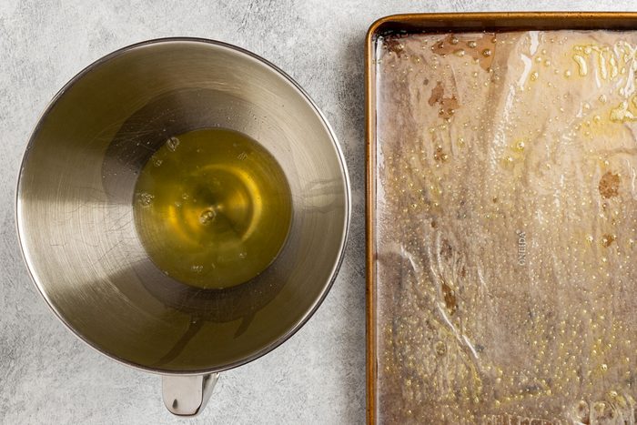 Taste of Home Jelly Roll recipe photo of the egg whites in a mixing bowl and the baking pan with wax paper.