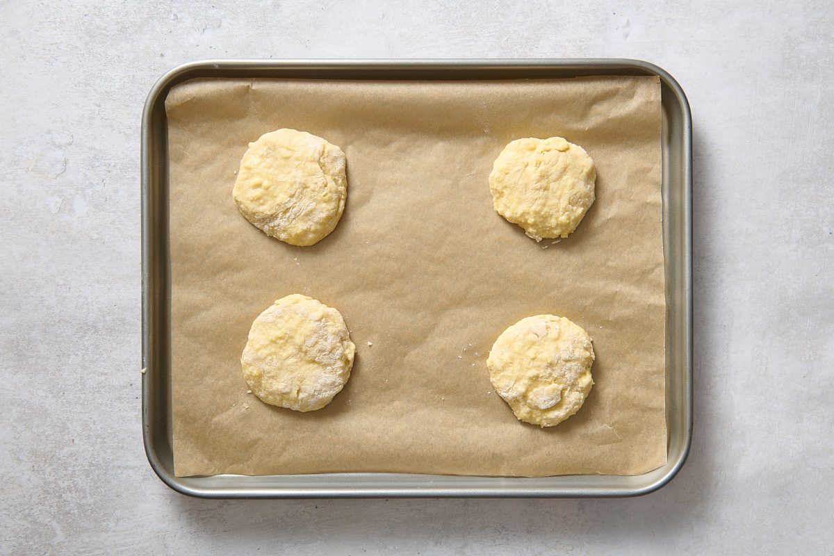 Lemon strawberry shortcakes cut out onto a baking sheet