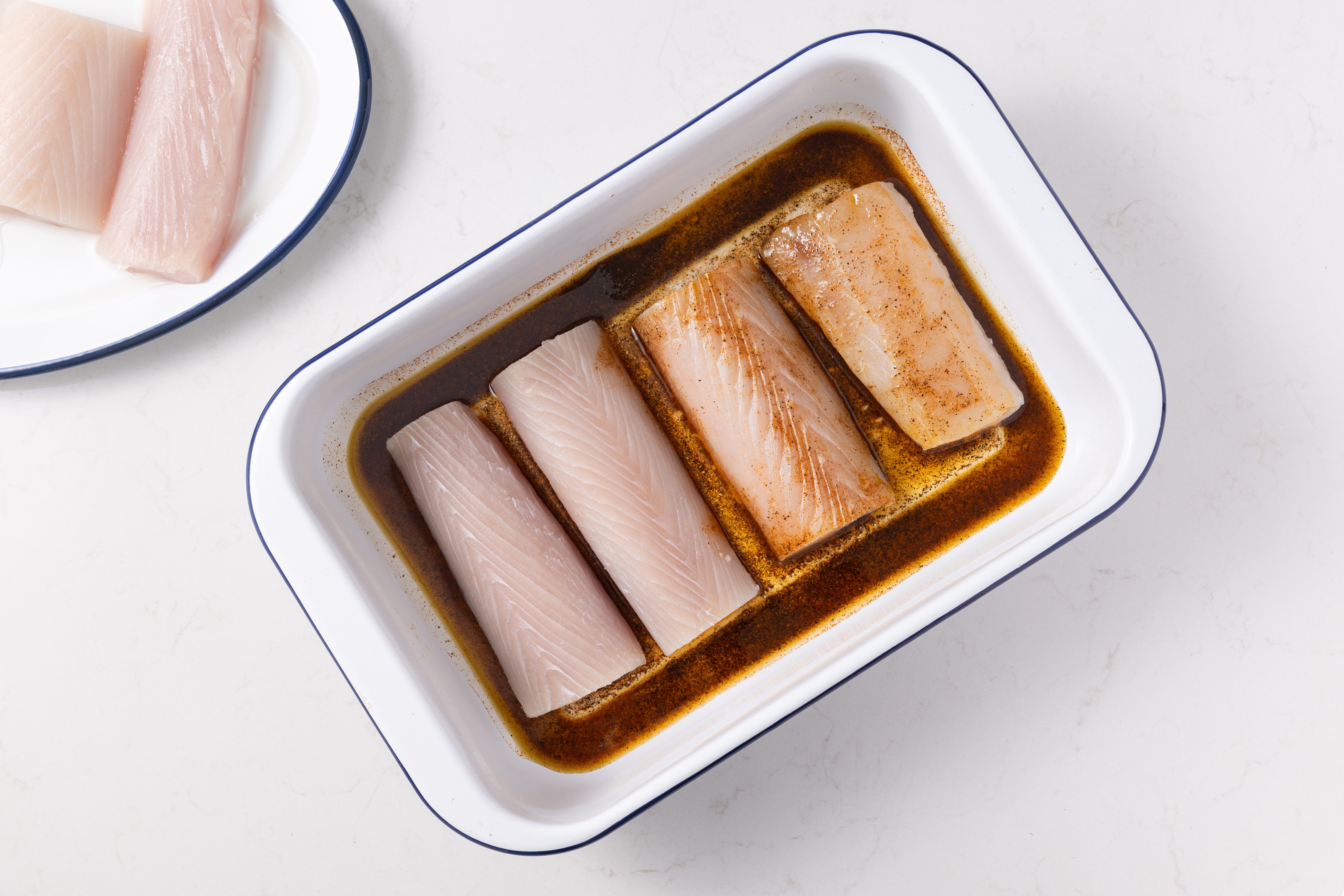 Mahi mahi fillets being marinated.
