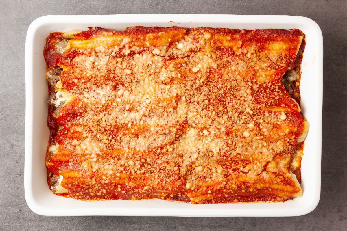 Step 6 of Taste of Home Meaty Manicotti is to cover and bake the manicotti for 40 minutes. Uncover the pan, and bake for 5 to 10 minutes longer, or until the top is bubbly and heated through.