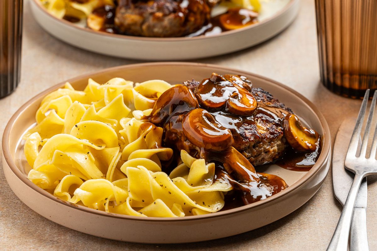 Old Fashioned Salisbury Steak on a plate with noodles