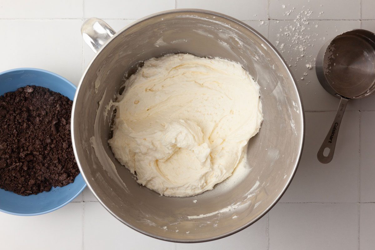 Step 4 of Taste of Home Oreo Cupcakes is to combine the softened butter, confectioners' sugar, milk and vanilla, then beat the mixture together until it’s smooth. Fold in the Oreo crumbs.