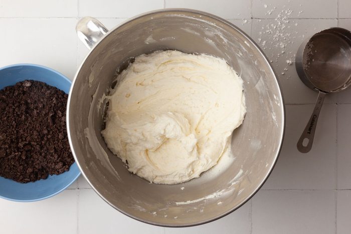 Step 4 of Taste of Home Oreo Cupcakes is to combine the softened butter, confectioners' sugar, milk and vanilla, then beat the mixture together until it’s smooth. Fold in the Oreo crumbs.