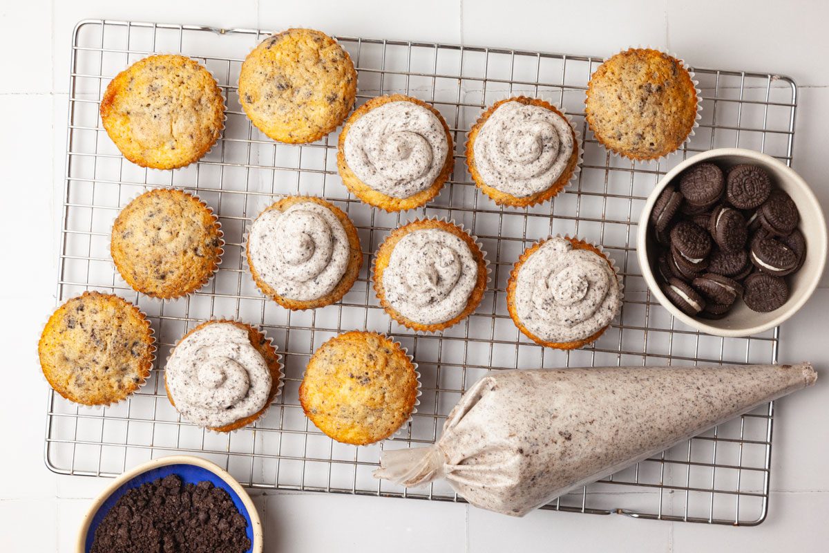 Step 5 of Taste of Home Oreo Cupcakes is to pipe or spread the frosting on top of the cupcakes. If desired, sprinkle the tops with additional cookie crumbs and garnish them with mini Oreo cookies.