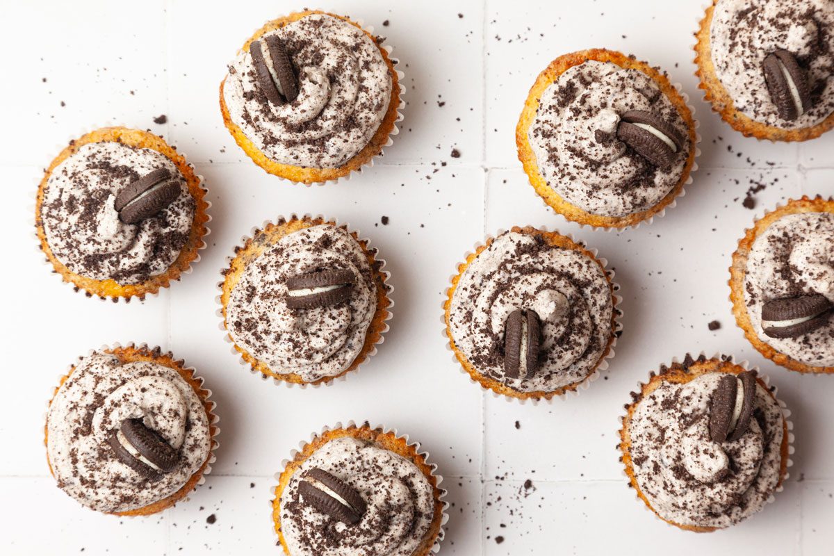 Taste of Home Oreo Cupcakes, on a white tile, oreo crumbs on surface
