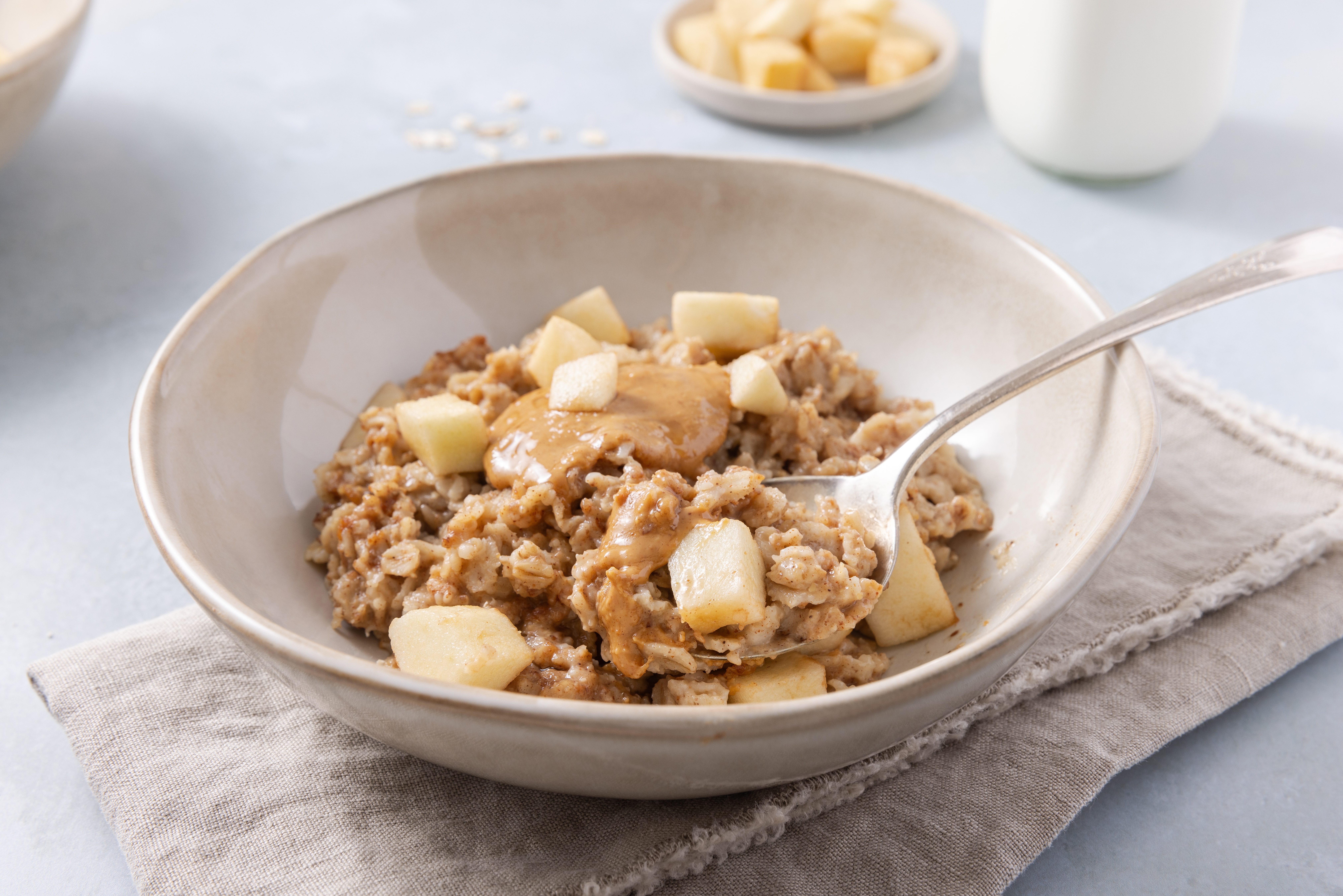 Close up of peanut butter oatmeal on spoon.