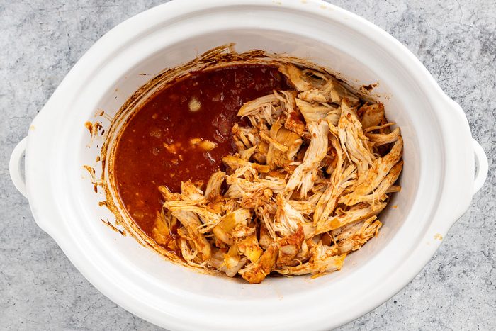 Taste of Home Pulled Chicken Sandwich recipe photo of the cooked, pulled chicken and sauce in the slow cooker.
