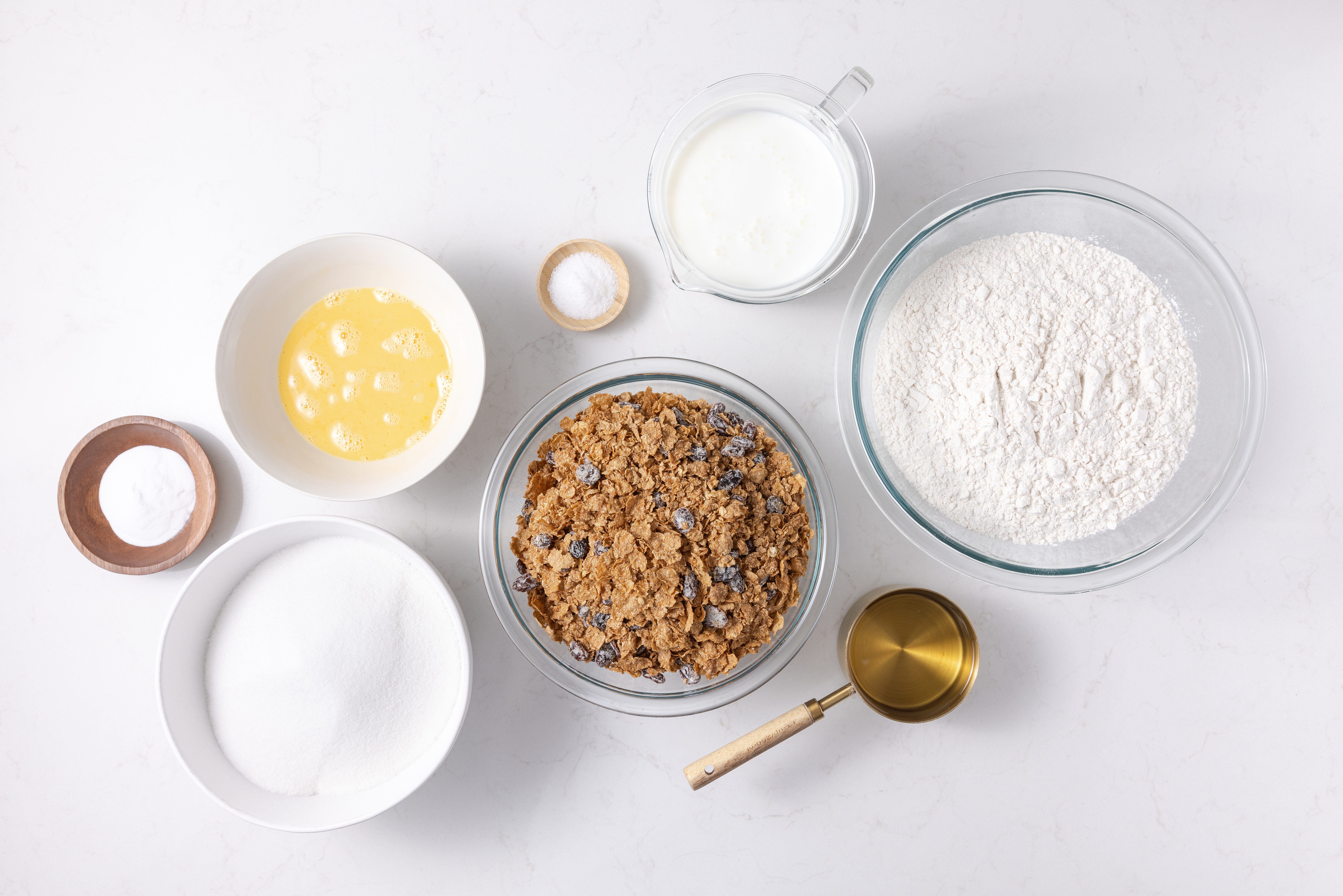 Ingredients for raisin bran muffins on kitchen counter.