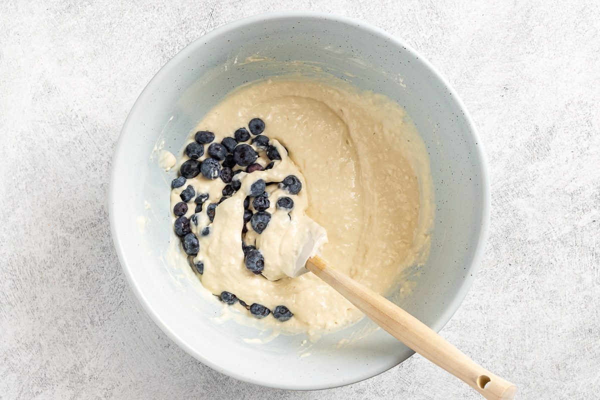 Taste of Home Small Batch Pancakes recipe photo of folding in the blueberries into the combined wet and dry ingredients.