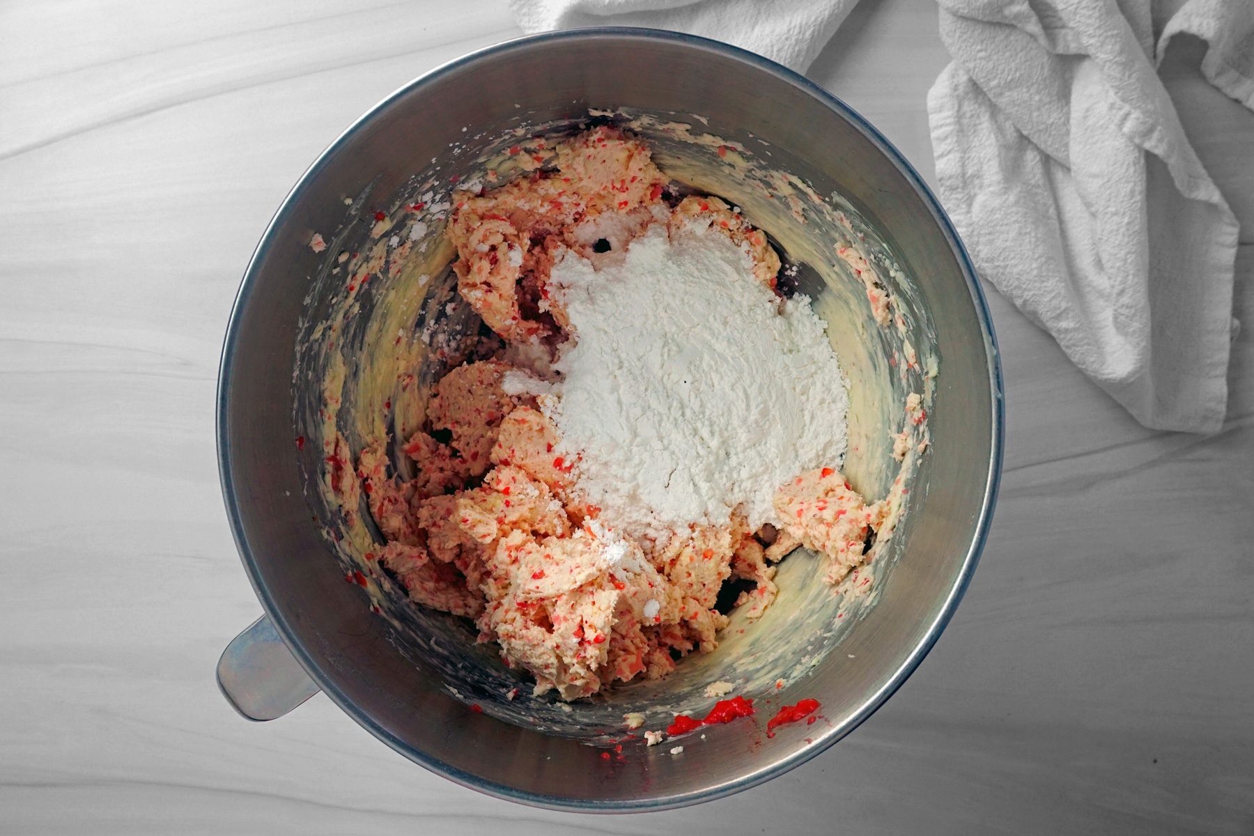 Adding flour and confectioners' sugar into the mixture