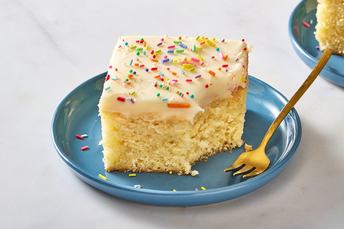 Closeup shot of a slice of sugar cookie cake with a forkful taken out of it