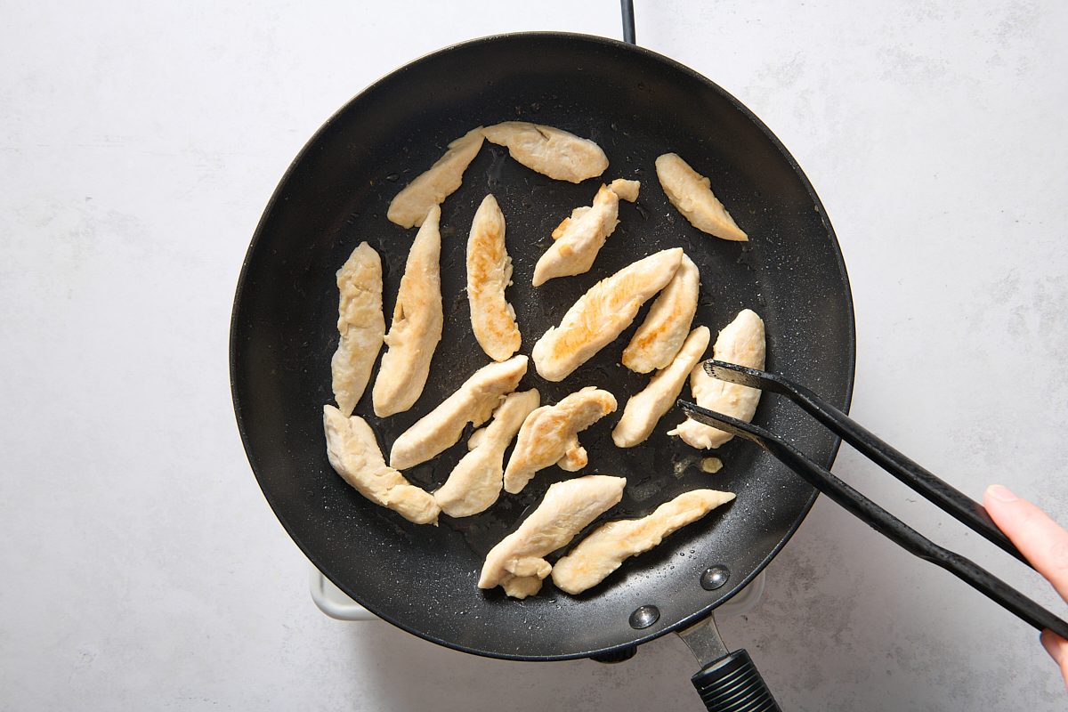 Cooking the seasoned chicken in a skillet
