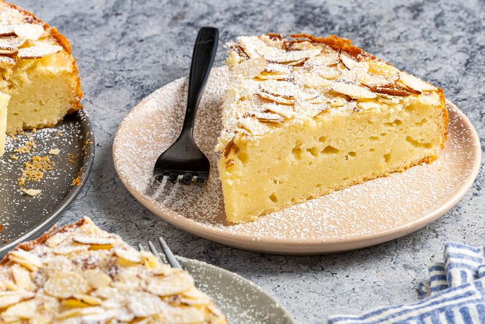 Taste of Home Almond Ricotta Cake photo of the finished recipe cut into slices and served on plates.