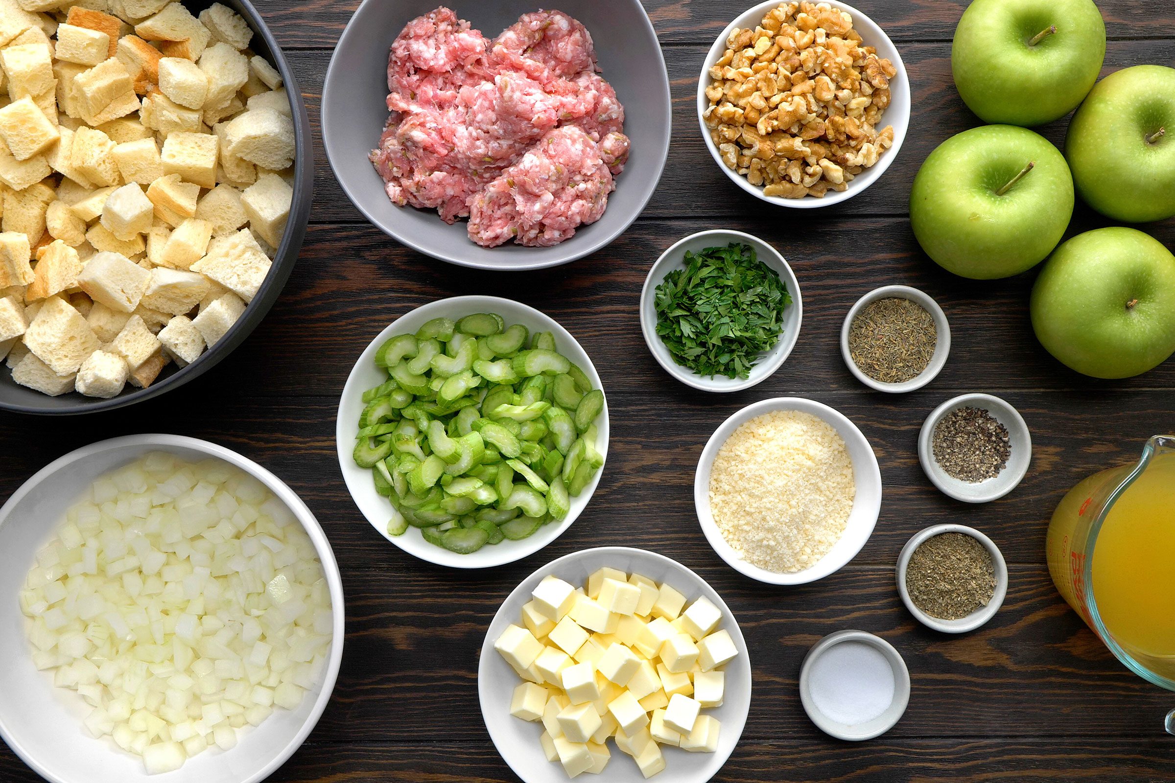 Aromatics, herbs, butter, parmesan cheese, chicken broth, apples, walnuts, bread cubes, ground sausage